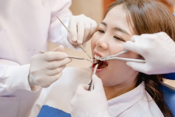 Dentist examining  teeth patients in clinic for better dental health and a bright smile.